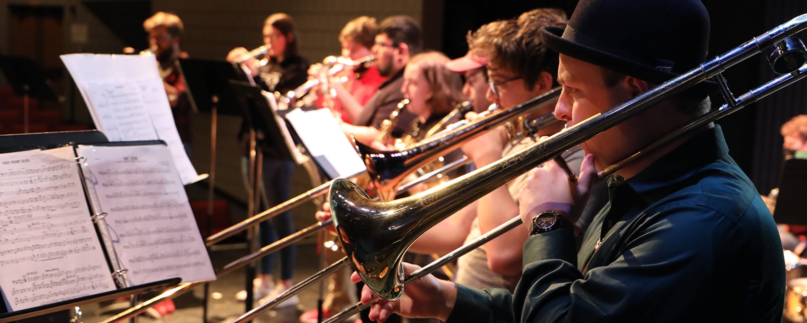 Band students performing with trombones